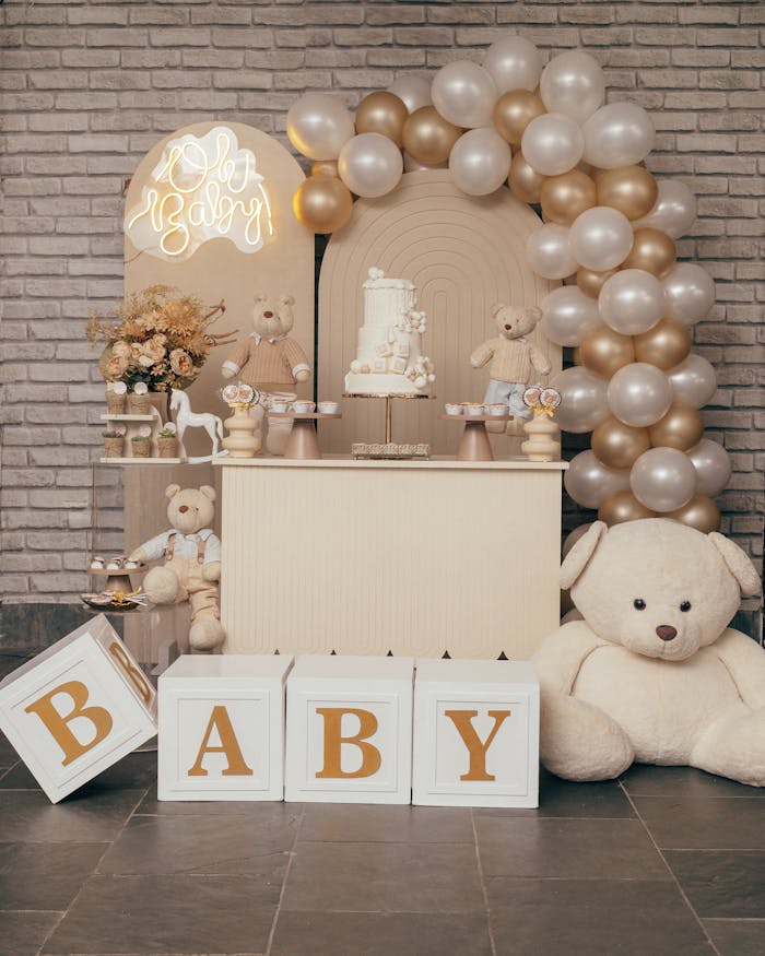 Charming baby shower setup with teddy bears, balloons, and elegant decor in soft tones.