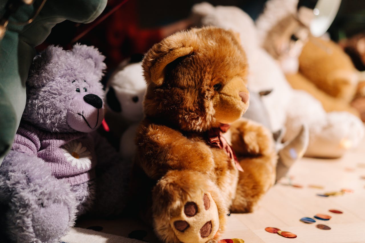Charming close-up of assorted plush teddy bears with warm lighting.